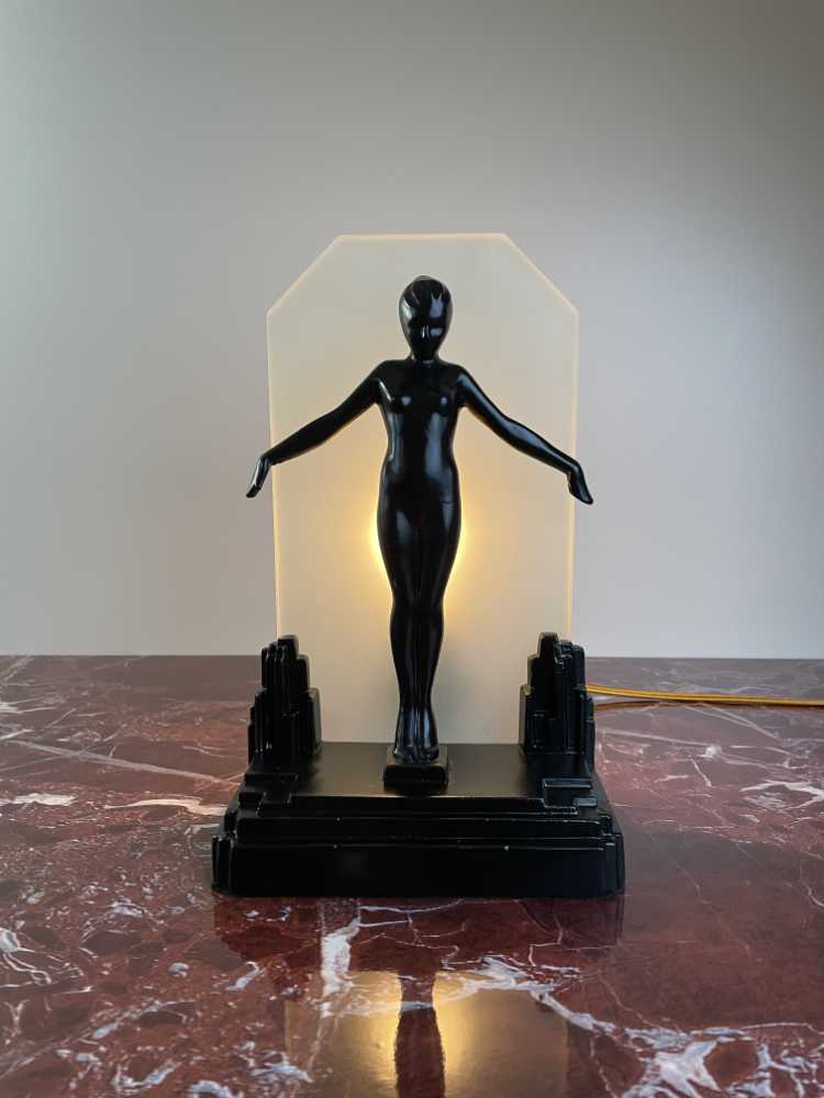 frankart lamp lady with arms outstretched in front of glass